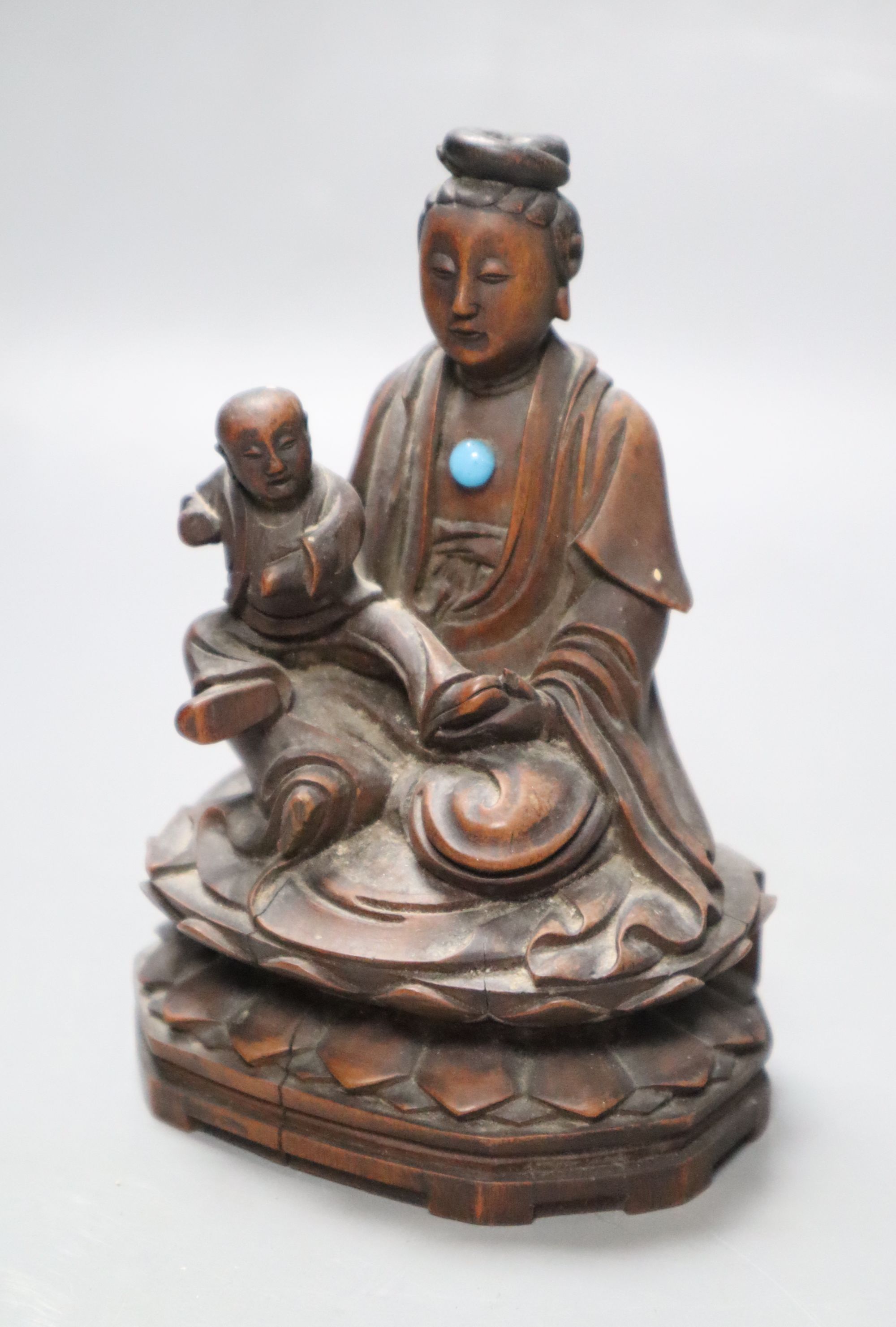 A 19th century Chinese wood group of Guanyin and a child, height 13cm